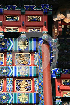 Painted and sculpted patterns decorate a gate (China)