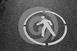 Painted sign on asphalt for pedestrian lane