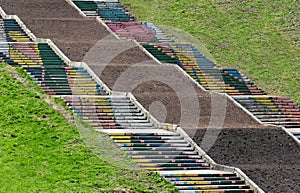 Painted steps of old stairway on a grassy slope in a park