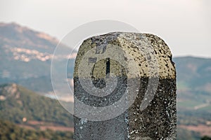 Painted stone road marker in Balagne region of Corsica