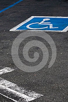 Painted symol of handicap parking only sign in blue and white