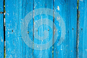 Painted vibrant blue old wooden planking background with flaws