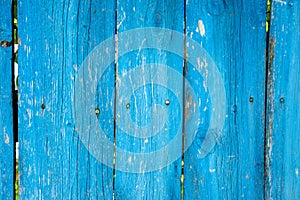 Painted vibrant blue old wooden planking background with flaws photo