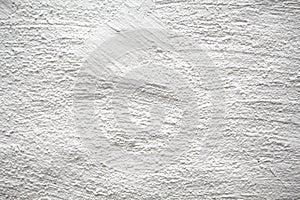 Painted wall with subtle texture closeup photo. White plaster with brushed texture.