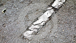 Painted white line of a road eroded