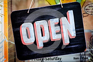 Painted Wood Open Sign in a Glass Window