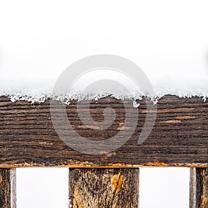 Painted wooden board and rungs covered with snow