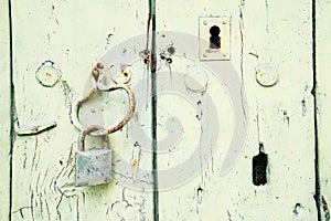 Painted wooden door with padlock and keyhole