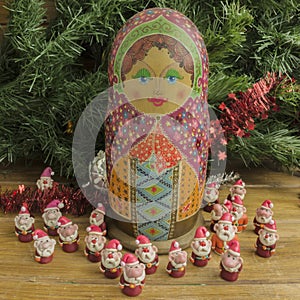 Painted wooden matrioshka doll and Santa Clauses from modeling clay.