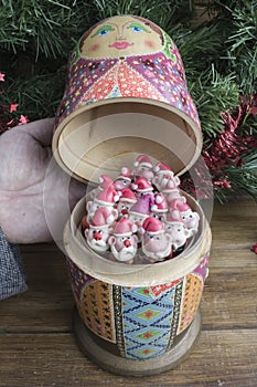 Painted wooden matrioshka doll and Santa Clauses from modeling clay.