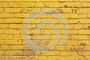 Painted yellow brick wall background texture in bright tints. photo