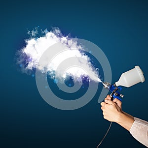 Painter with airbrush gun and white magical smoke