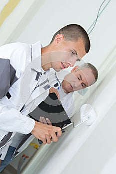 Painter with apprentice at construction site