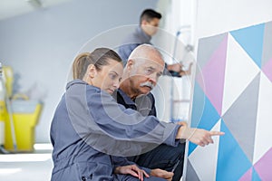 Painter with apprentice in training room