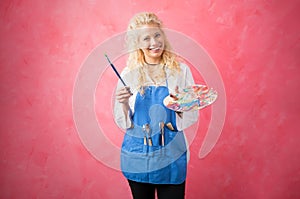 Painter with brush and paint palette in hands