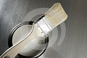 Painter brush and white paint tin