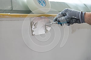 Painter filling an interior wall - craftsmen