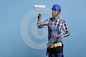 Painter focused on work holding professional roller