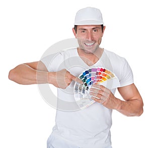 Painter holding a paint roller and spectrum