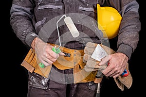 Painter holding a wall brush in his hand. Accessories for small home repairs