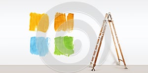 Painter ladder with paint colors samples, isolated on wall