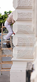 Painter on a ladder at work