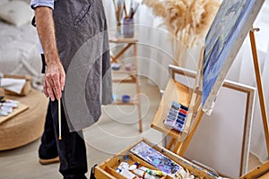 painter man in apron during work process