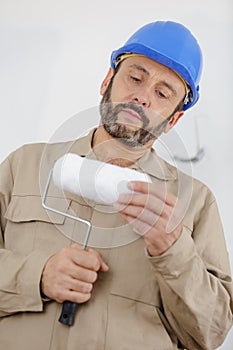 Painter man checking roller