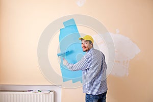 The painter man painting the wall at home