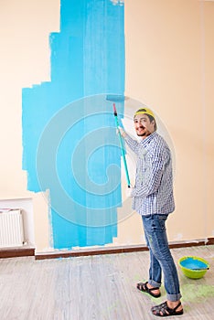 The painter man painting the wall at home