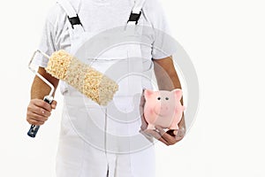 Painter man with roller brush and piggy bank, isolated on white