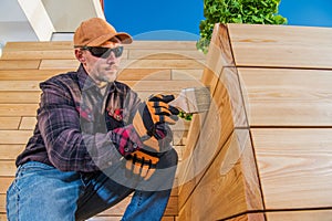 Painter Oiling Wooden Planks With Brush