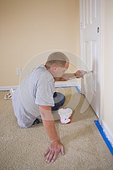 Painter painting bedroom door