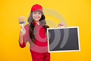 Painter with painting brush tool or paint roller hold blackboard. Worker  on yellow background. Kids renovation