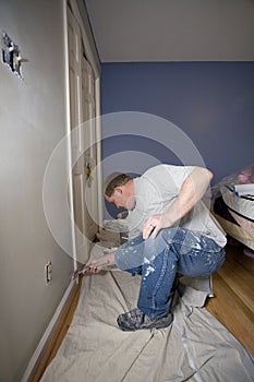 Painter painting trim