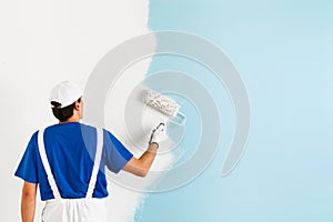 Painter painting a wall with paint roller