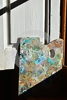 a painter's palette next to a window