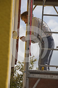 Painter on scaffold photo