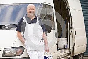 Painter standing with van