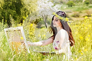 Painter woman is create picture outdoors