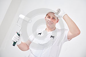 Painter worker portrait with roller painting