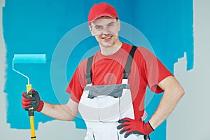 Painter worker with roller at wall paintingS