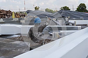 The painter is working to fireproof paint on steel structure with spray gun, at industrial factory