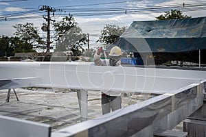 The painter is working to fireproof paint on steel structure with spray gun, at industrial factory