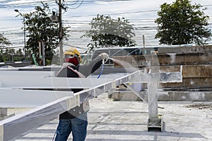 The painter is working to fireproof paint on steel structure with spray gun, at industrial factory