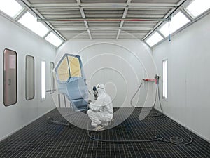 Painter works in a spray booth