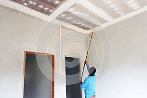 Painters are painting the ceiling of a new home photo