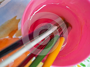 Painting brushes in the cup of water