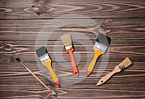 Painting brushes on a wooden table