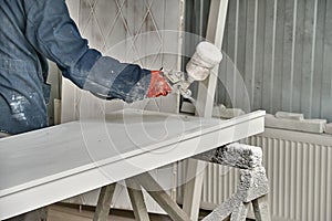 Painting cabinets with spray gun . Painting chamber, spray gun. Furniture manufacture